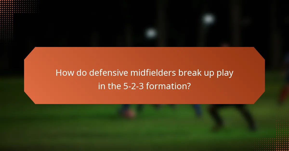 How do defensive midfielders break up play in the 5-2-3 formation?