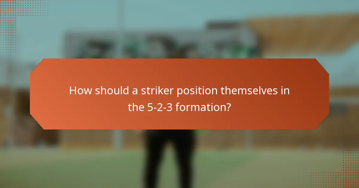 How should a striker position themselves in the 5-2-3 formation?
